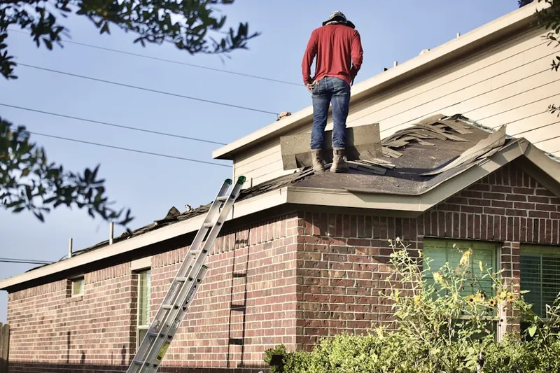 Professional roofer working on a residential roof in Beckett Ridge